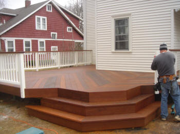 ipe deck with fan stairs and white vinyl rails